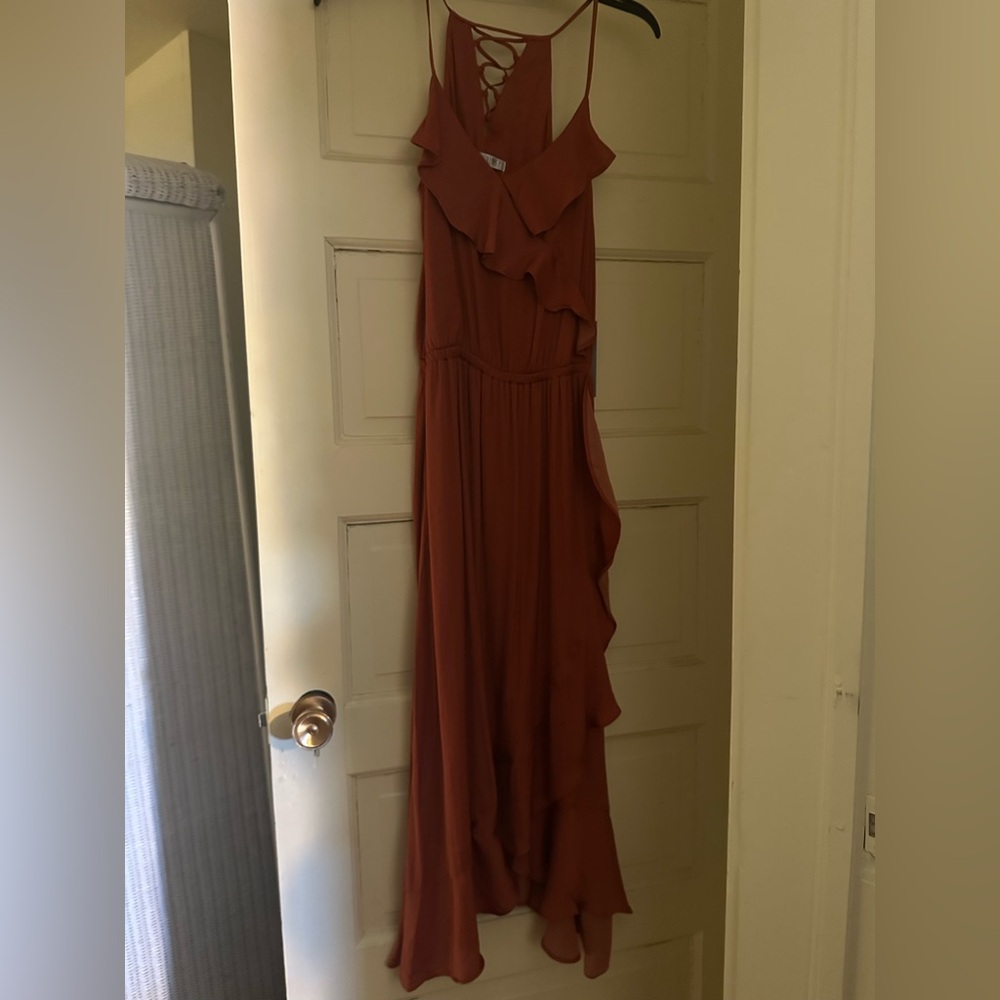 New with tags, never worn, gorgeous Jennifer Lopez rust colored dress. Size XS.